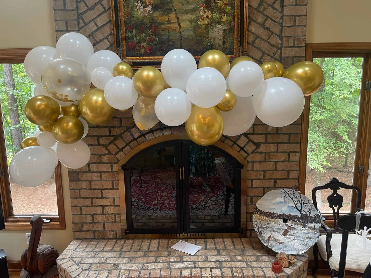 Elegant white and gold balloon garland over a fireplace