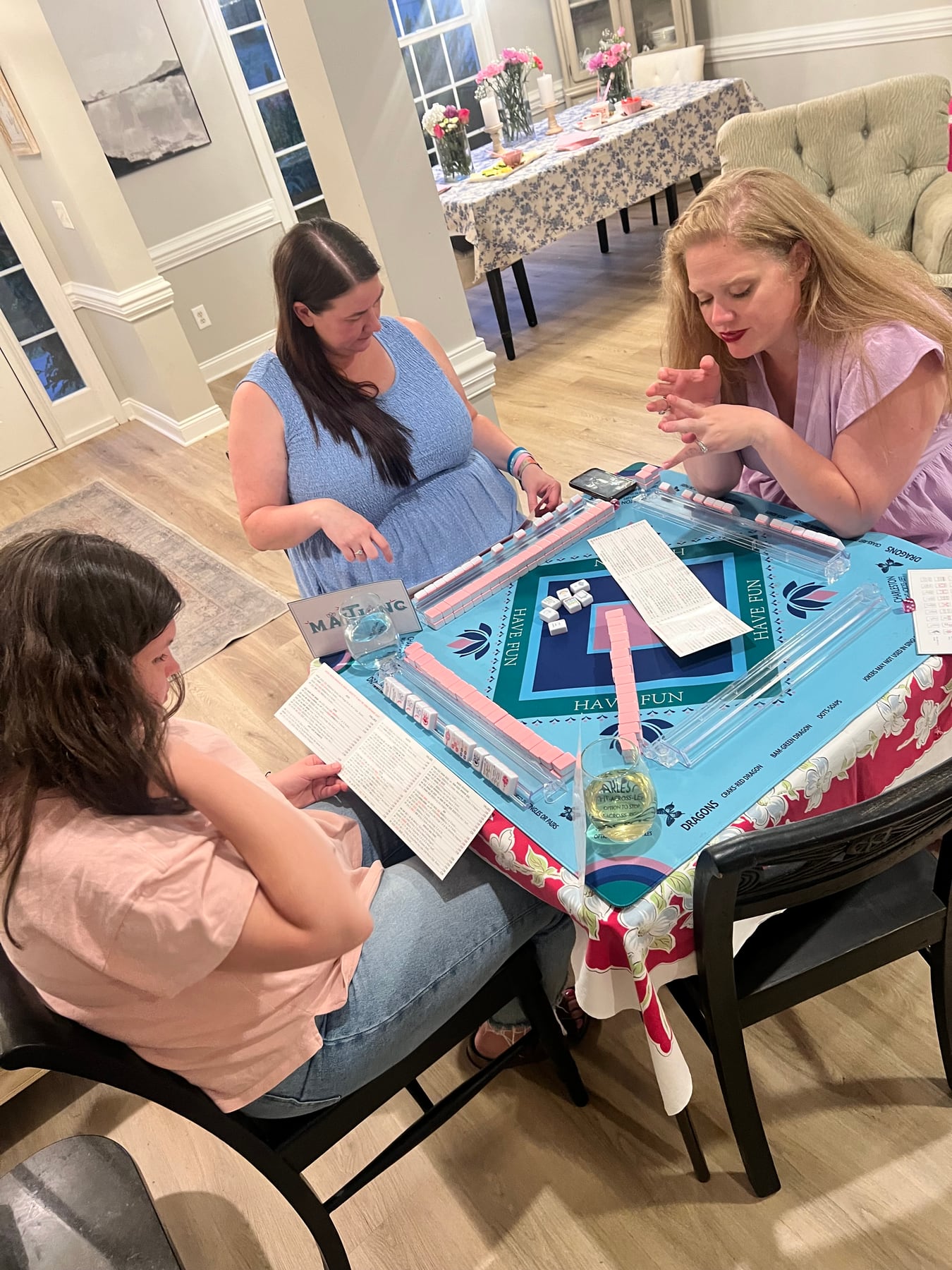 Beginner Mahjong players learning together around the table
